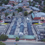 Aerial visualization of alternative development plan featuring the historic train sheds with north and south parking lots